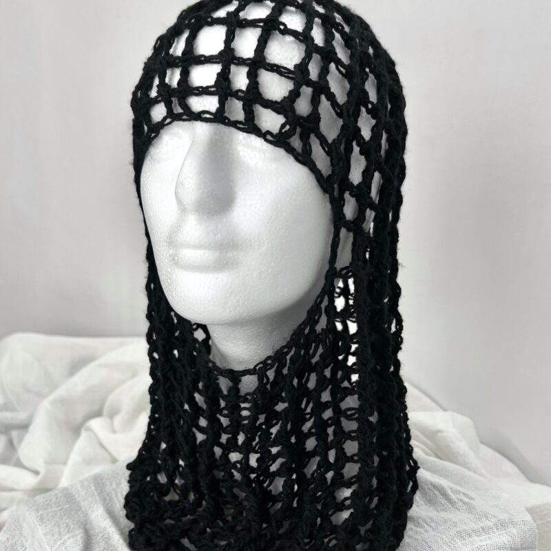 Handmade black crochet headpiece by ThreadXDreads featuring an open-net hood design and draped crochet detailing